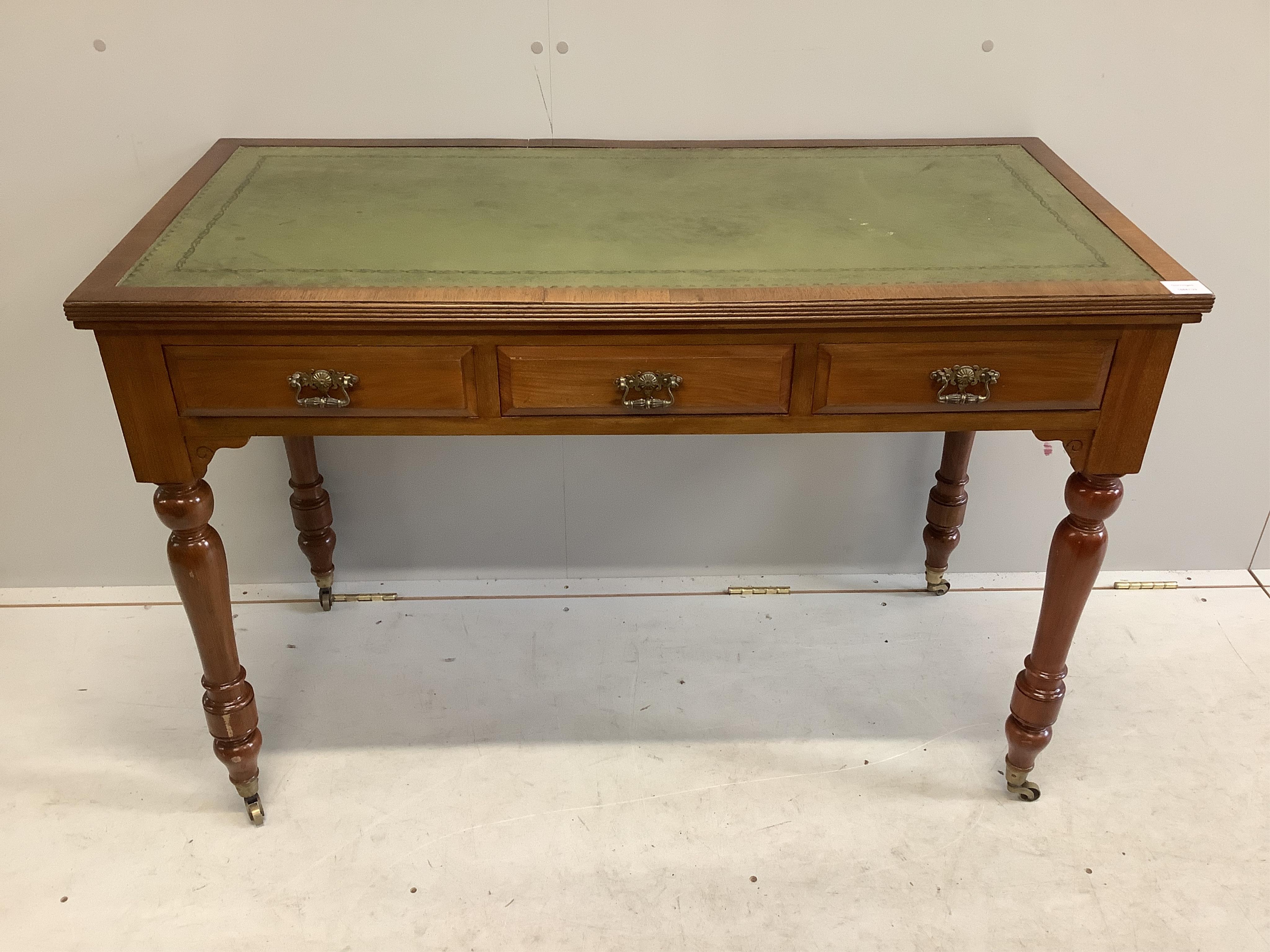 A late Victorian mahogany three drawer writing table, with an inset leather top, width 113cm, depth 55cm, height 77cm. Condition - fair to good, one piece of veneer detached but present